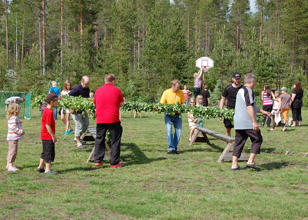 People raising the maypole at the midsummer celebration
